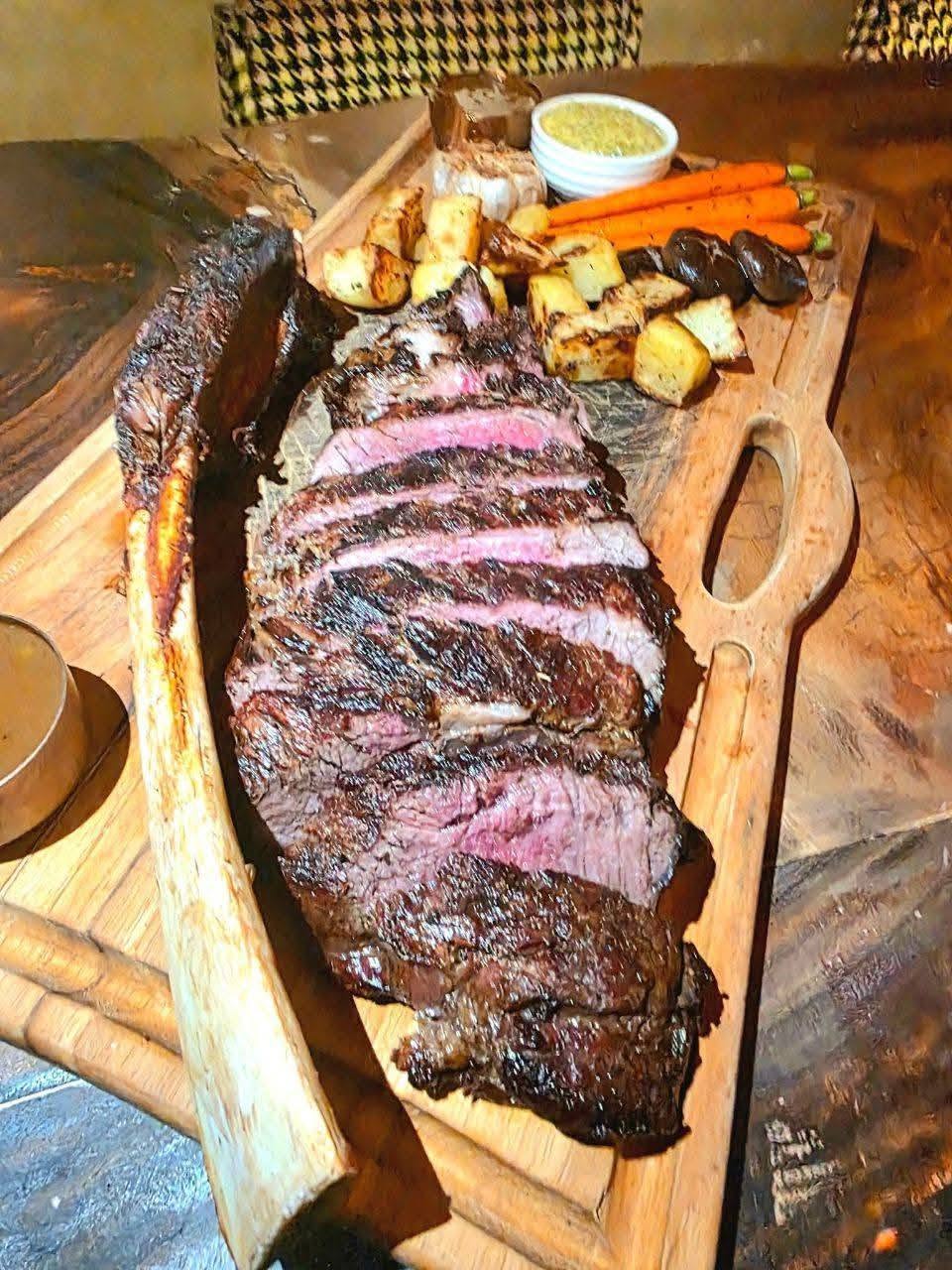 Grilled steak served on a wooden board
